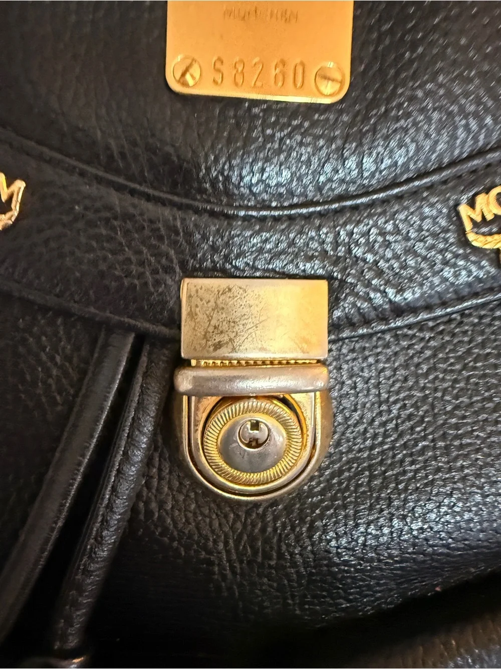 MCM Black Leather Backpack with Gold Accents and Front Pockets